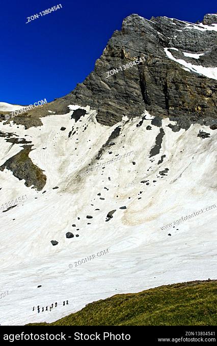 Alpinisten überqueren ein Schneefeld im Salentse Kar auf dem Weg zur Rambert Hütte, Grand Muveran Massiv hinten, Ovronnaz, Wallis
