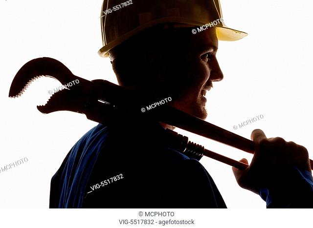 Ein Arbeiter in einem Gewerbebetrieb ( Handwerker ) mit Werkzeug in der Hand -Austria, 02/09/2014