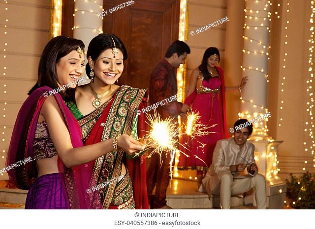 Women playing with sparklers