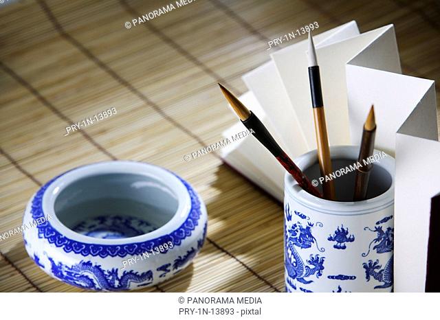 Still life of writing brushs, brush pot and book