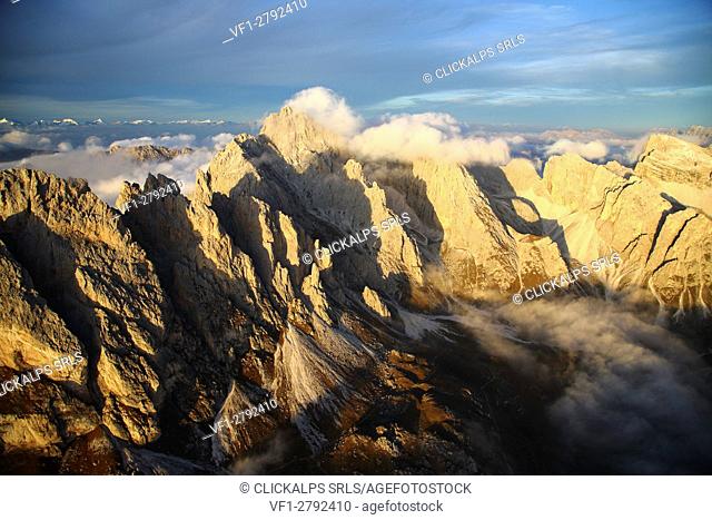 Aerial view of the mountain range of Odle surrounded by clouds. Dolomites Val Funes Trentino Alto Adige South Tyrol Italy Europe
