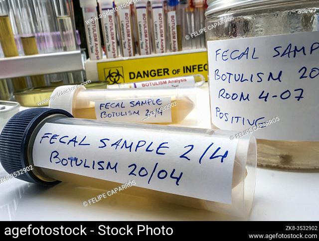 Fecal sample of a person infected with botulism, infection in tin cans in poor condition, conceptual image