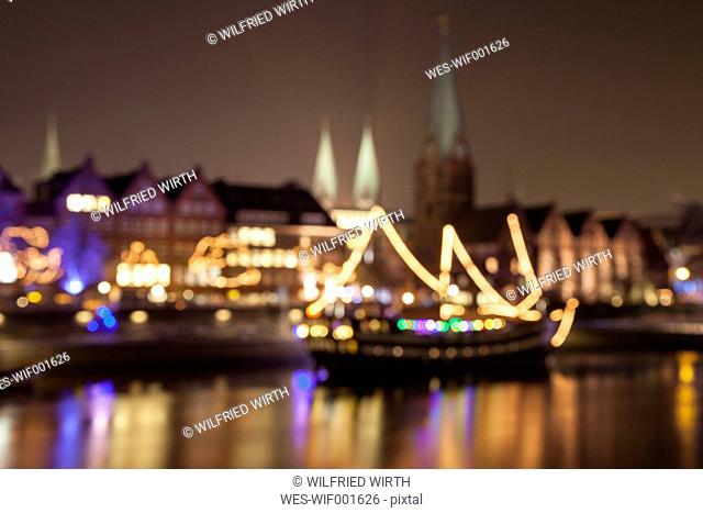 Germany, Bremen, blurred view to lighted historic old town at night