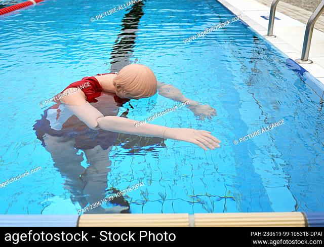 14 June 2023, Berlin: A special mannequin lies in the pool at the Humboldthain summer pool during the pre-swim of potential lifeguards
