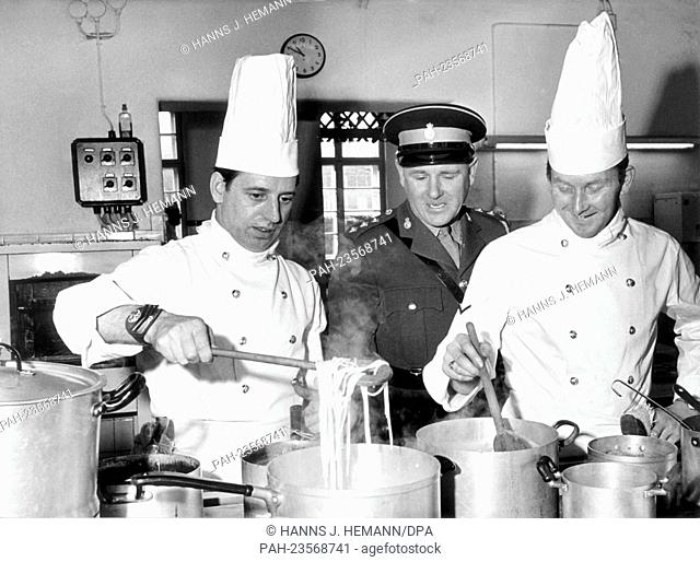 Two chefs of the British army are observed by a member of the jury (m) while preparing food during the cooking contest in Bielefeld on the 7th of February in...