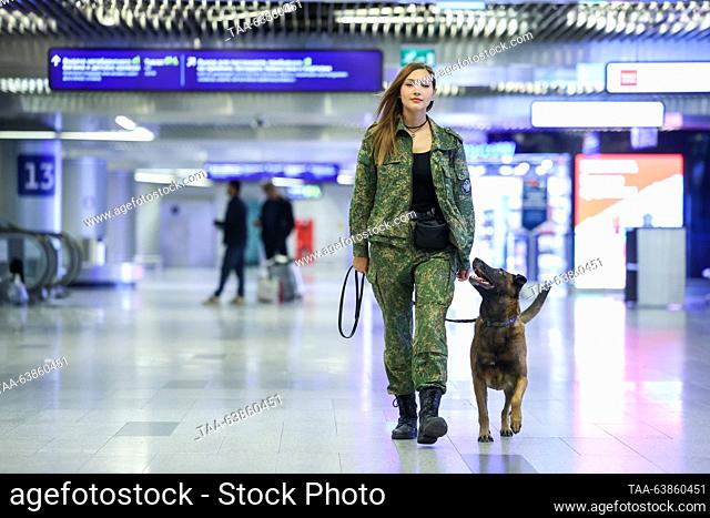 RUSSIA, MOSCOW - OCTOBER 25, 2023: A K9 officer and a service dog patrol Vnukovo International Airport. Valery Sharifulin/TASS