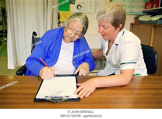 Occupational therapist with patient doing Rey figure copying test, which detects perceptual defects following stroke