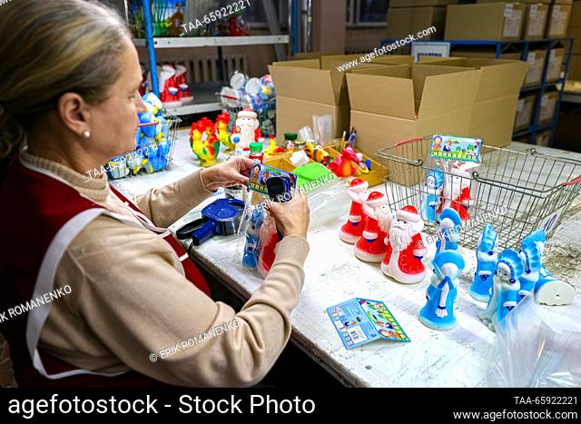 RUSSIA, VORONEZH - DECEMBER 19, 2023: An employee packages Christmas ornaments at the Igrushki toy factory. The enterprise is engaged in production of PVC...