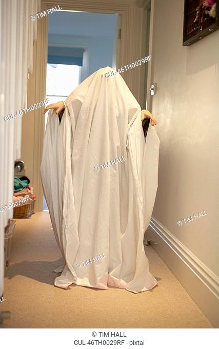 Child wearing ghost Halloween costume
