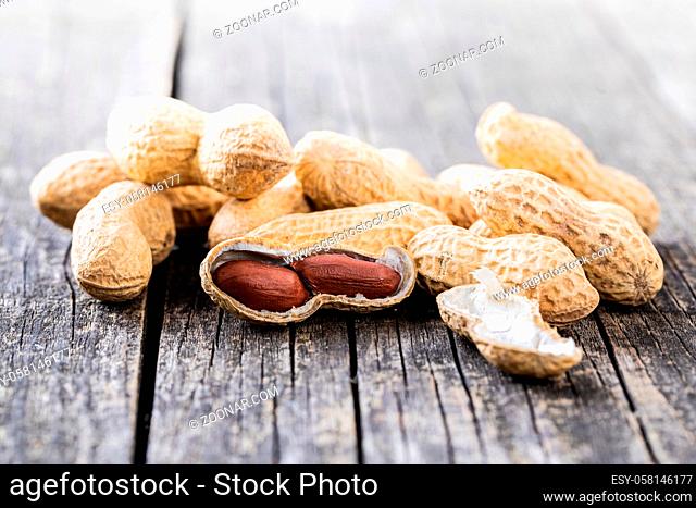 Roasted peanuts. Tasty groundnuts on wooden table