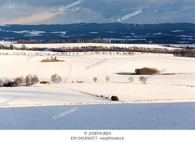 Wooden fence in snowy winter country landscape, weather forecast concept