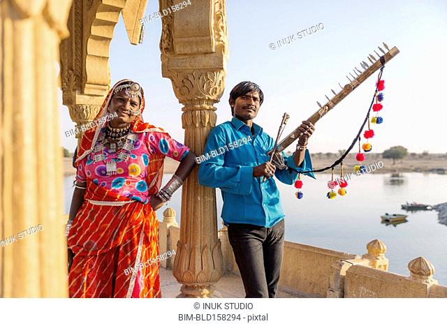 Traditional Indian couple standing in monument, Jaisalmer, Rajasthan, India