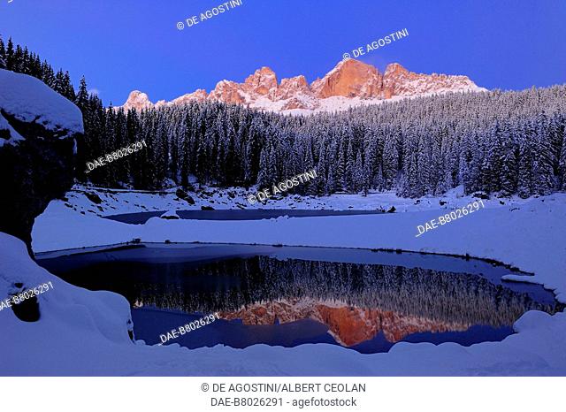Lake Carezza, with the Catinaccio group in the background, snowy landscape, Trentino-Alto Adige, Italy