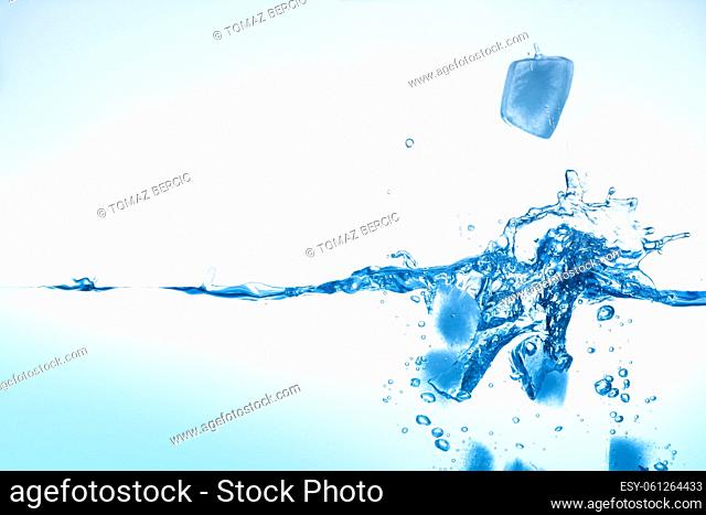Ice cubes faling in water, high contrast