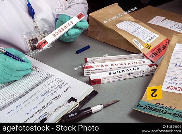 police scientist takes data from evidence box in crime lab, conceptual image
