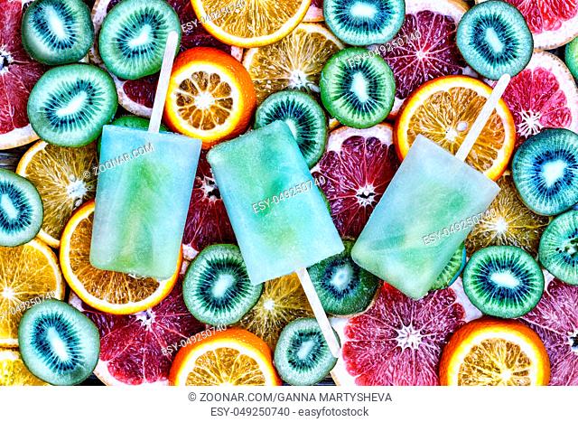 Fruit ice, sliced fruit, kiwi, orange, grapefruit. Concept: summer, heat, quenching thirst