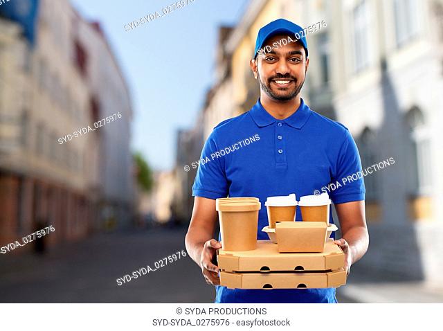 indian delivery man with food and drinks in city