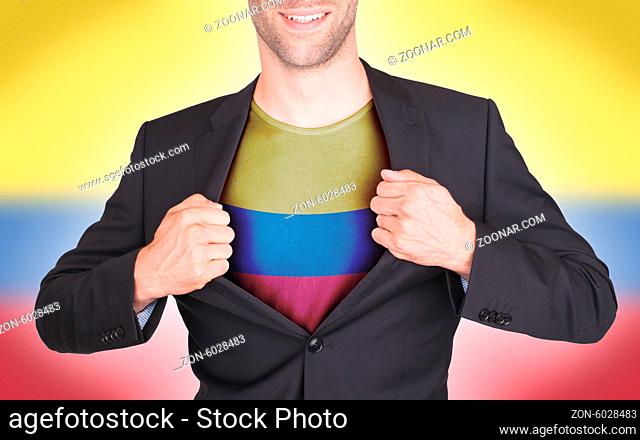 Businessman opening suit to reveal shirt with flag, Colombia
