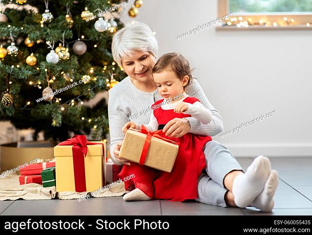 grandmother and baby girl with christmas gifts