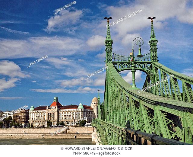 Freedom bridge across the Danube River at Budapest, Hungary  The landmark Gellert Hotel is on the shore of the Danube on the Buda side of the River