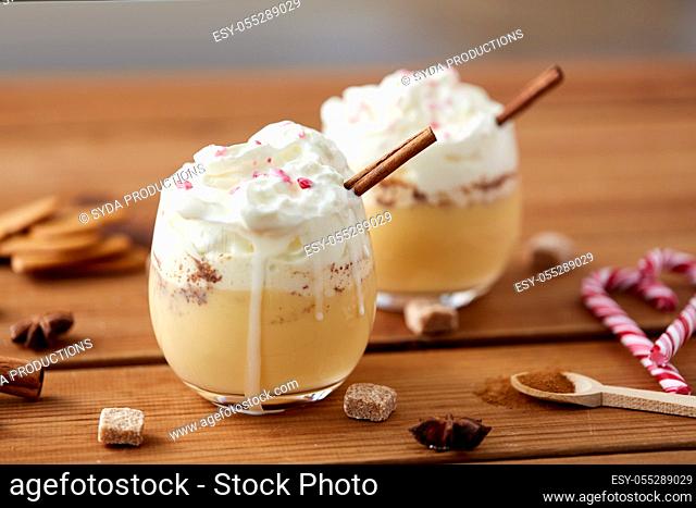 glasses of eggnog with whipped cream and cinnamon