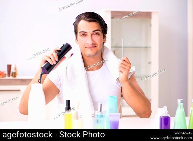 Young handsome man in the bathroom in hygiene concept