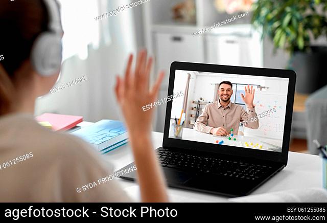 student with laptop having online class at home
