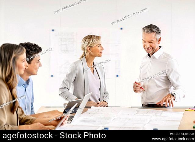 Senior businessman and woman leading workshop in office