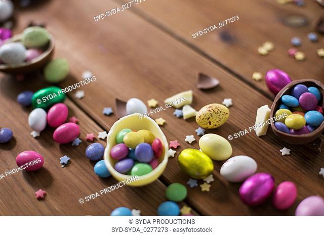 chocolate eggs and candy drops on wooden table