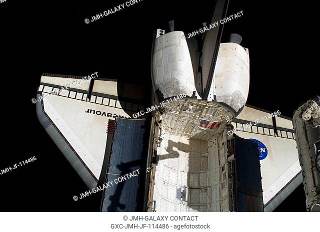 Space shuttle Endeavour's aft payload bay, orbital maneuvering system (OMS) pods, vertical stabilizer and wings are featured in this image photographed by an...