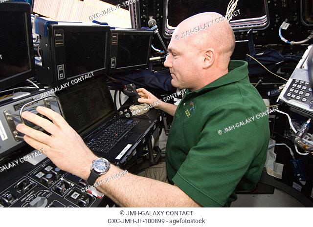 European Space Agency astronaut Andre Kuipers, Expedition 30 flight engineer, works the controls of the Canadarm2 Space Station Remote Manipulator System...