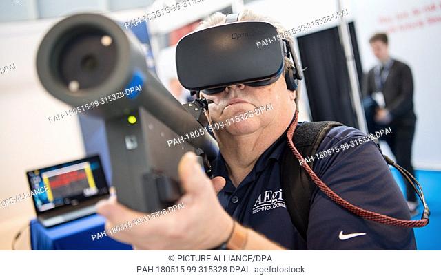 15 May 2018, Germany, Stuttgart: An employee of the company Aegis uses the virtual reality simulator Virtual Stinger Trainer on the first day of the ITEC fair...