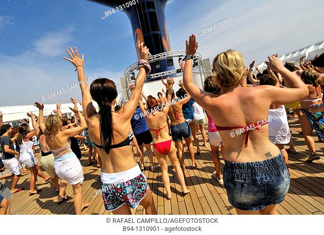 Women dancing on the deck of a cruise ship