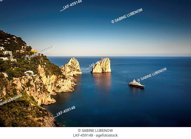 Yacht in front of the Faraglioni Stacks, Capri, Bay of Naples, Campania, Italy