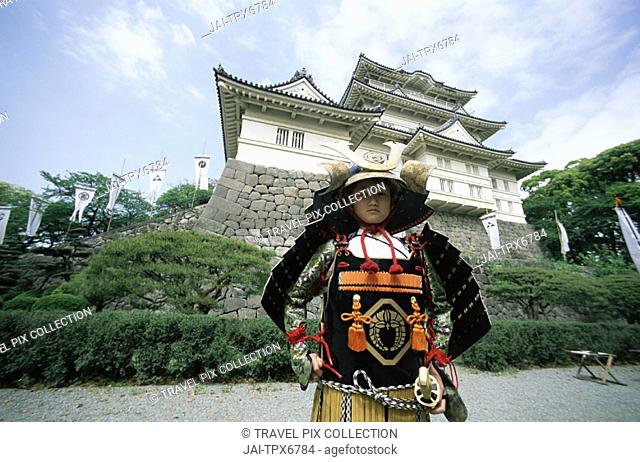 Japan, Kanagawa, Odawara, Young Boy Dressed in Samarai Costume in front of Odawara Castle