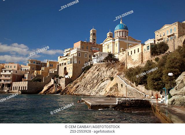 People in swimmsuites with the Neo Classic Greek Orthodox Church of Saint Nicholas at the background, Ermoupolis, Syros, Cyclades Islands, Greek Islands, Greece