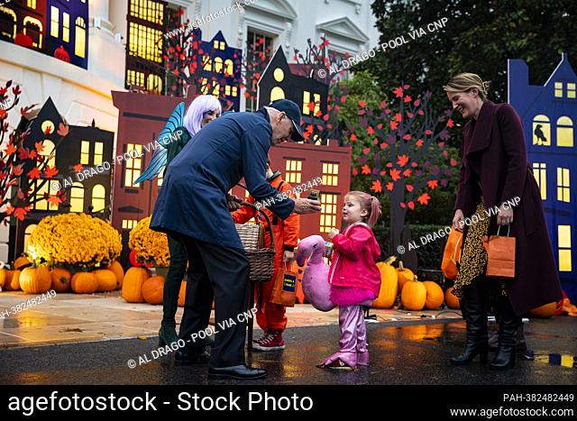 US President Joe Biden and First Lady Jill Biden greet children dressed up in costumes during a Halloween event on the South Lawn of the White House in...