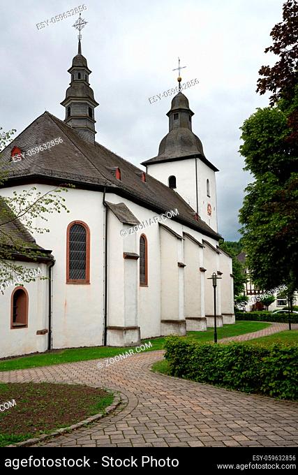 View along a footpath to the parish church of the Sauerland village Oberkirchen, Schmallenberg, Germany