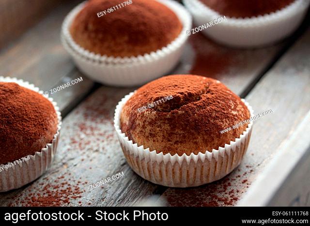 Muffins with spelt flour and cocoa in a wooden box on a table, closeup