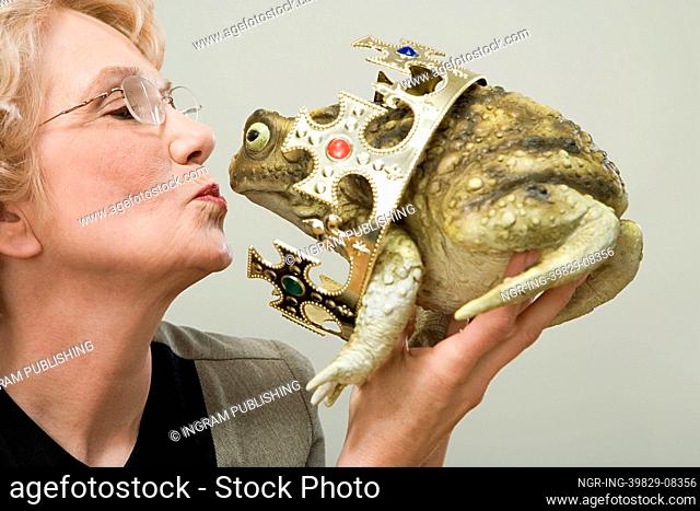 Woman kissing frog