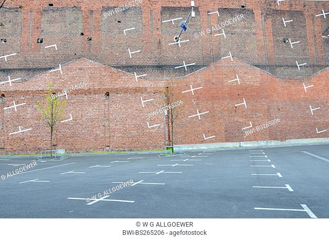 art project: the parking bays painted on a parking lot extended onto the wall of a bordering building, Germany, North Rhine-Westphalia, Cologne