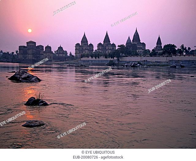The domes and spires of the chhatris memorials to Bundelkhand's former rulers from across the Betwa River at sunset