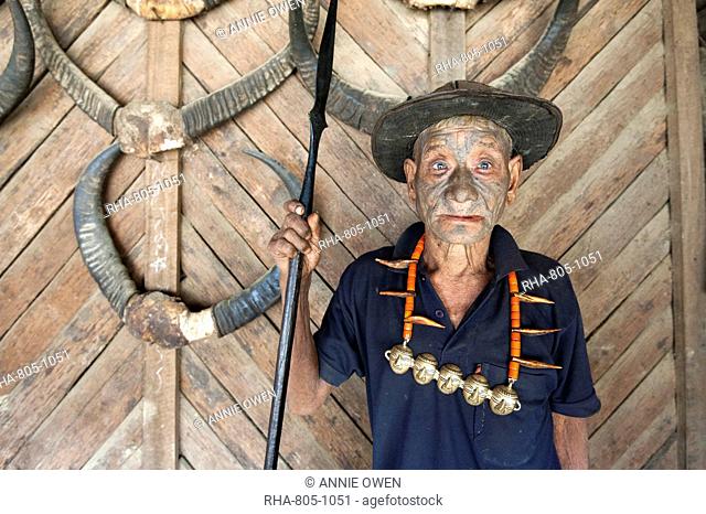 Wangchah Wangsa, Naga headhunter, with tattooed face and Naga tribal necklace, holding hunting spear, Longwa village, Nagaland, India, Asia