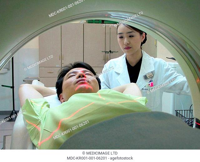 A patient undergoes a CT scan under care of staff at the Samsung Medical Center