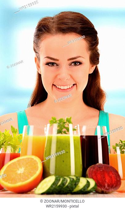 Young woman with variety of vegetable and fruit juices. Detox diet