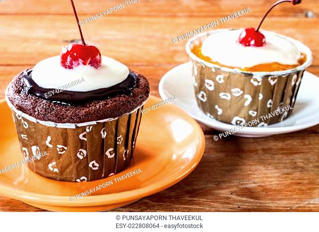 Chocolate and Butter Marmalade Cupcakes decorated with red cherry