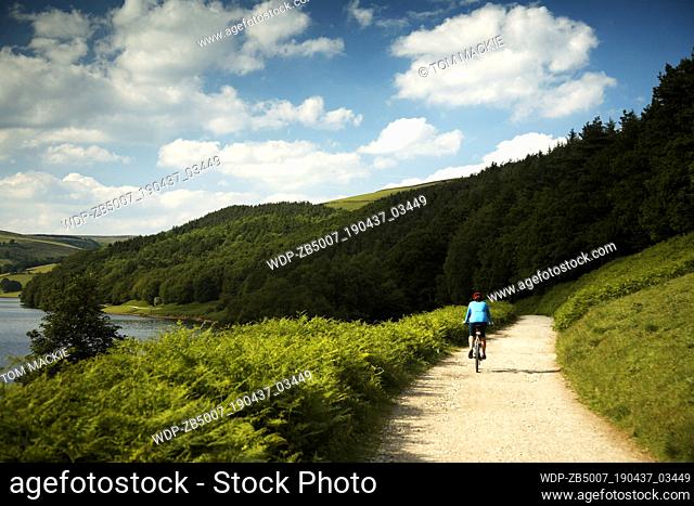 Mountain biker by Derwent Water, Peak District National Park, Derbyshire, England