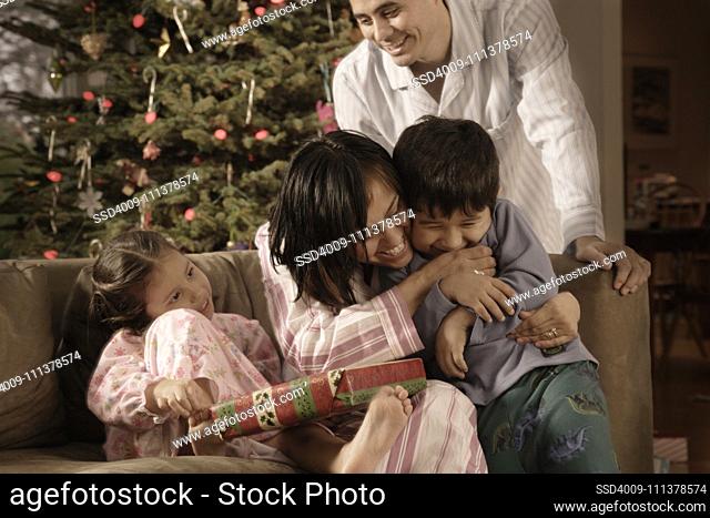 Hispanic family hugging on Christmas