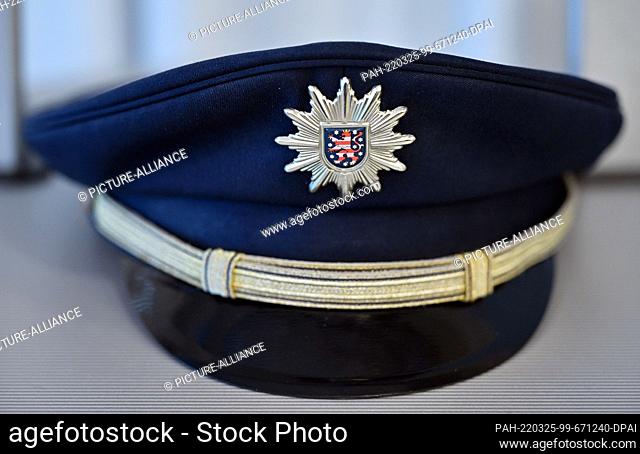 25 March 2022, Thuringia, Erfurt: The service cap of a Thuringian police officer lies on a table during a press conference to present the police crime...