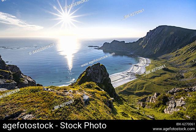 Sun shining over the sea, cliffs, beach and sea, hiking to the mountain Måtinden, near Stave, Nordland, Norway, Europe